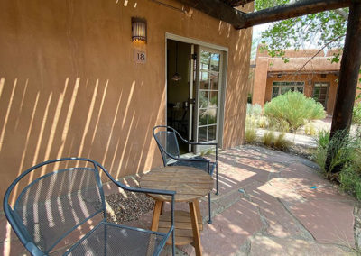 adobe hotel back porch with patio furniture