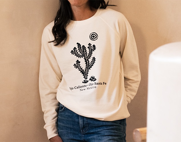 Sweatshirt that has a graphic of a cactus and says Ojo Caliente - Ojo Santa Fe New Mexico