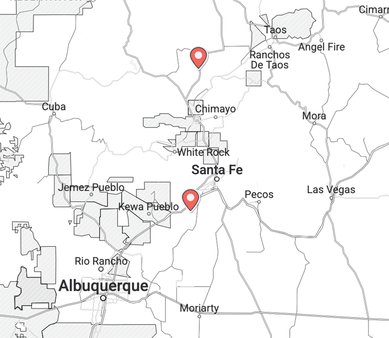 Ojo-Spa-Resorts-New-Mexico-Map A map of northern New Mexico showing Santa Fe and Albuquerque, with two location markers: one near Chimayo and another south of Santa Fe. Major highways and nearby towns are labeled.