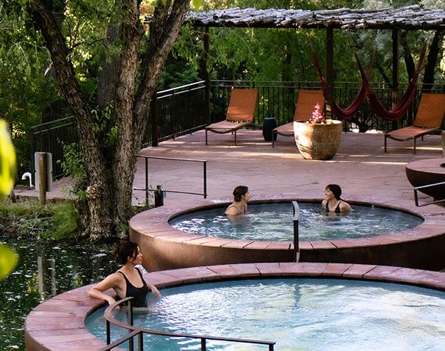 Three hot tubs overlooking pond