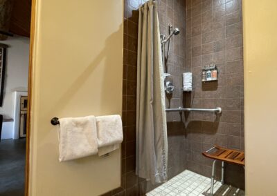 Pueblo Suite ADA Shower with grab bars and stool